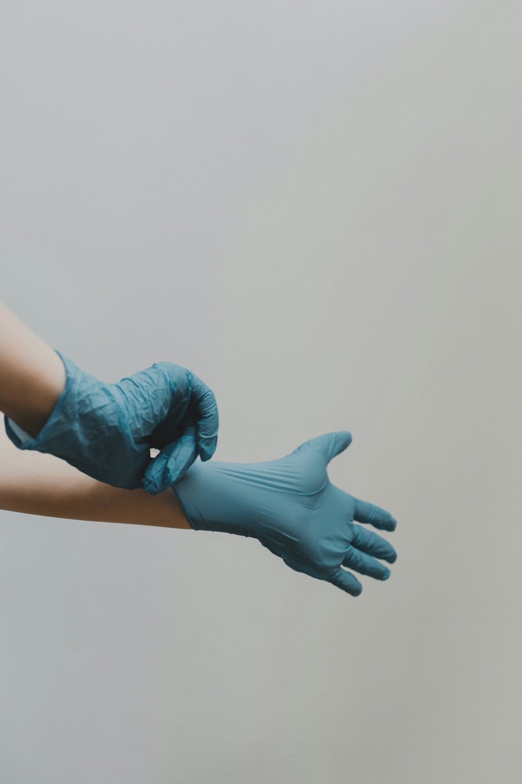 Putting on nitrile gloves before a cleaning appointment